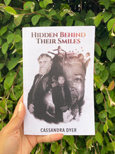 Load image into Gallery viewer, Hidden Behind Their Smiles Novel Signed Copy By Author Cassandra Dyer